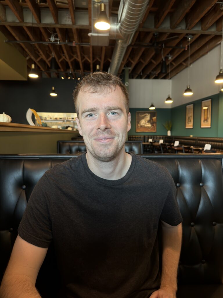 Young guy sitting in restaurant